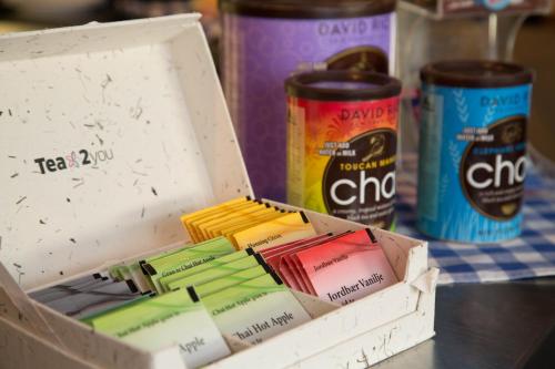 a box full of packets of tea jam and cans of soda at Dinners Mellerud in Mellerud