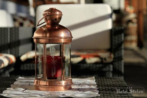 a glass jar with a redactedactedactedactedacted at Hotel Stalon Alpine Chic in San Martino di Castrozza
