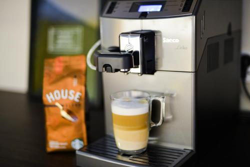 a coffee machine with a glass of beer in it at SAHIL Hostel & Hotel in Baku
