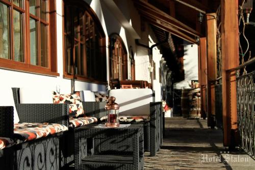 an alley with chairs and a bottle on a table at Hotel Stalon Alpine Chic in San Martino di Castrozza