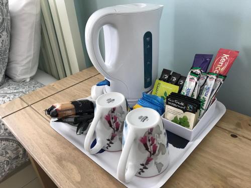 a table with three white coffee mugs on it at Crofthead Farm House in Tarbolton