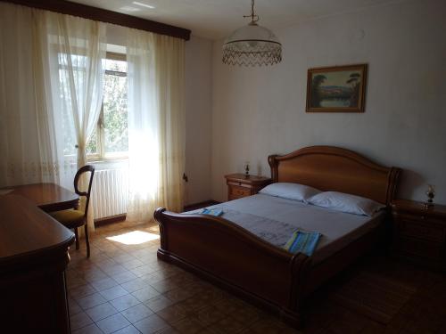 a bedroom with a large bed and a window at Apartment Via Montenegro in Ghilarza