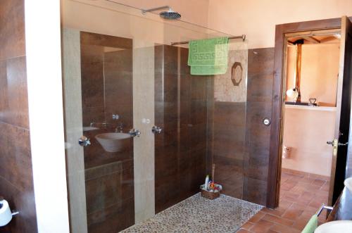 a bathroom with a shower with a sink at Ca Na Marina in Cala Llombards