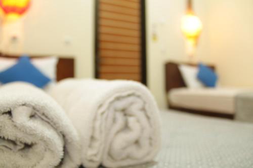 a hotel room with towels on a bed at Chillin Kuta Homestay in Kuta