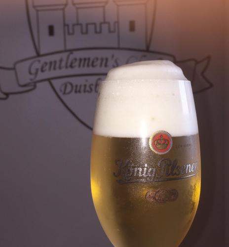 a close up of a glass of beer at Hotel Goldener Hahn in Duisburg