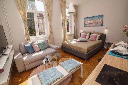 a small living room with a couch at Doma Zagreb Aparthotel in Zagreb