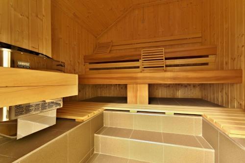 a sauna with a chair sitting in it at Wellness Hotel Republika 24 Apartments in Plzeň