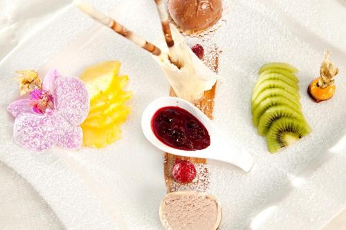 a white plate topped with different types of food at Landhotel Schneider in Riedenburg