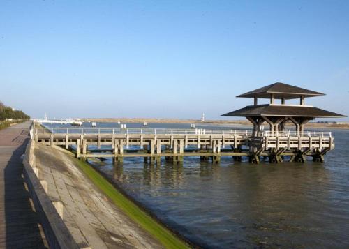 a pier with a gazebo on the water at Studio De Zunneblomme in Middelkerke
