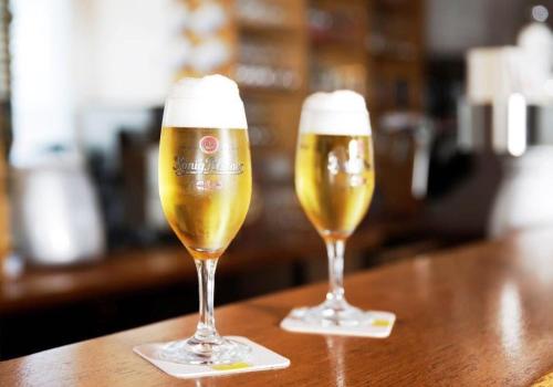 two glasses of beer sitting on a table at Hotel Goldener Hahn in Duisburg