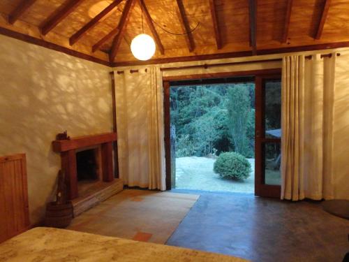 an empty room with a large sliding glass door at Estalagem Engenho de Serra - Parque Nacional do Itatiaia - Parte Alta in Itamonte
