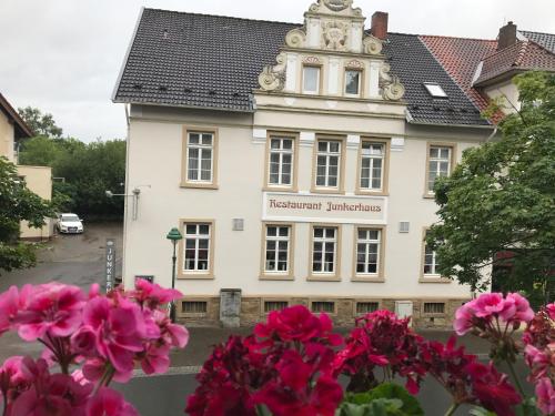 a building with pink flowers in front of it at Hotel Junkerhaus in Bad Salzuflen