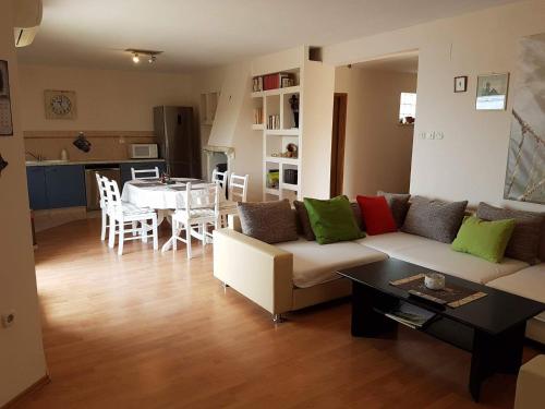 a living room with a couch and a table at Apartment Tempera in Povlja