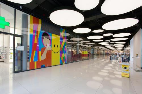 a hallway in a shopping mall with colorful paintings on the walls at Main Apartment Frankfurt Offenbach in Offenbach
