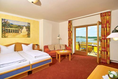 a hotel room with a bed and a balcony at Landhotel Wiesbauer in Füssen