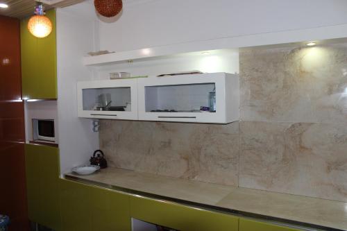 a kitchen with green cabinets and a counter top at Apartment at Milsa Nasr City, Building No. 36 in Cairo