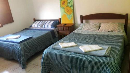 2 nebeneinander sitzende Betten in einem Schlafzimmer in der Unterkunft Casa do Gil in Tiradentes