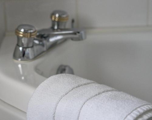 a towel is sitting on the edge of a bathroom sink at Tattykeel House in Omagh
