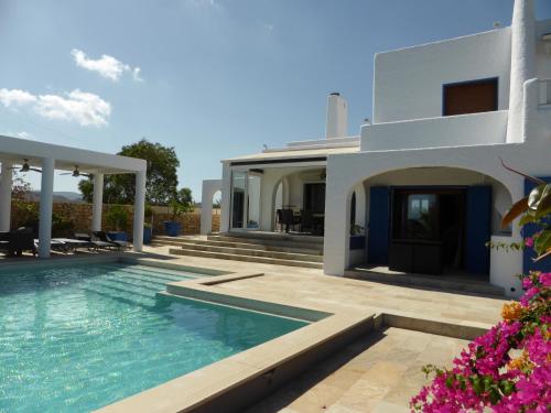 a villa with a swimming pool and a house at Villa Teresa in Agua Amarga