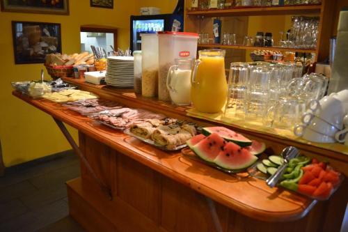 a buffet line with food and fruit on a table at Pension U Kostela in Frymburk