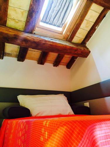a bedroom with a bed and a window in it at Navona Residenza de Charme in Rome