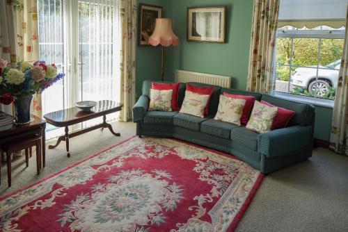 a living room with a couch and a red rug at Tattykeel House in Omagh