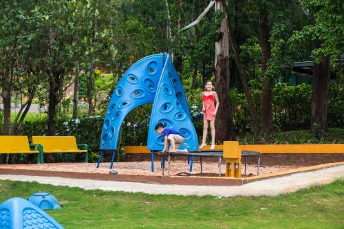 a young girl and a boy playing on a playground at Residency Lake Resort & Spa in Mulshi