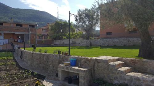 a stone retaining wall with a park in the background at Apartment Vujačić in Bar