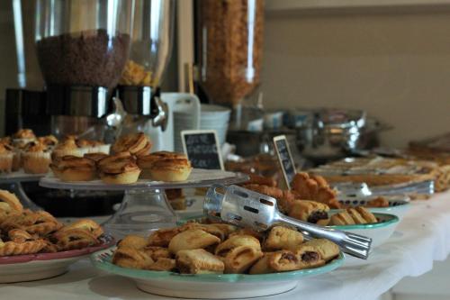 a table topped with plates of pastries and pies at Puntaquattroventi in Ercolano