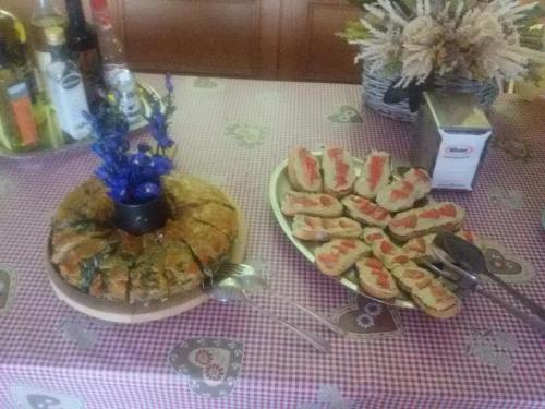 a table with two plates of food on a table at Albergo Posta in Colle Santa Lucia