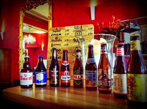 a group of bottles of beer sitting on a table at Hostel Lybeer Private Rooms just for two! in Bruges
