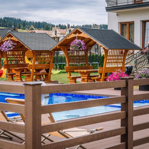 a backyard with a gazebo and a swimming pool at Hotel Liptakówka in Białka Tatrzanska