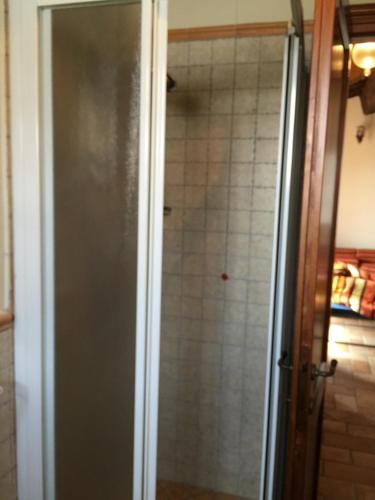 a shower with a glass door in a bathroom at Azienda Agrituristica I Tre Casali in Magione