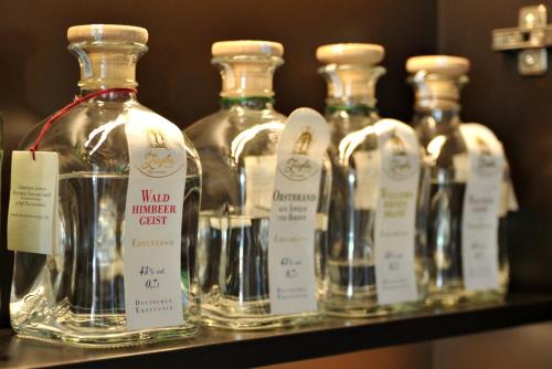 a group of bottles of liquor on a shelf at Hotel Restaurant Bürgerklause Tapken in Garrel