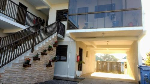 a house with a staircase and a stair case at Classe aluguéis apts in Imbé