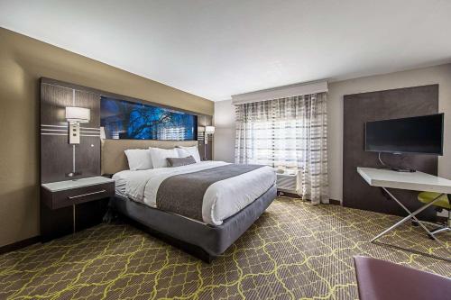 a hotel room with a large bed and a desk at Best Western Plus Clemson Hotel & Conference Center in Clemson