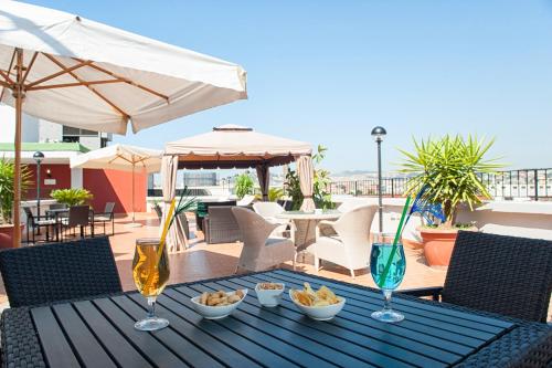 a table with food and drinks on a patio at Hotel Tiempo in Naples