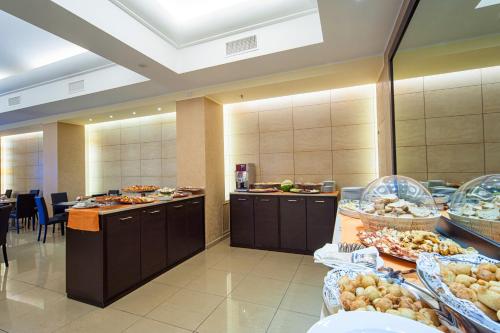 a buffet line with many plates of food in a restaurant at Hotel Tiempo in Naples