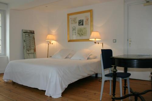 La Maison de la Plage tesisinde bir odada yatak veya yataklar