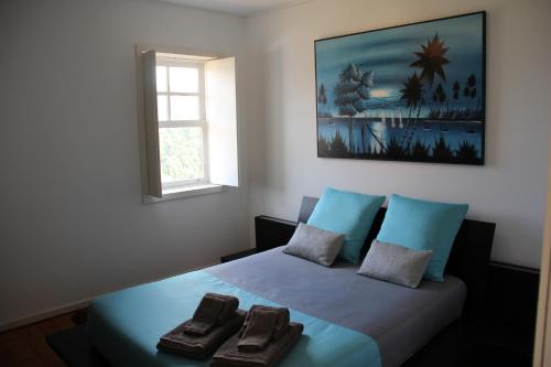 a bedroom with a bed with two towels on it at Casa da Bichaca in Castelo de Paiva