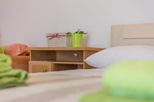 a bedroom with a bed and a table with a plant at Apartment Lavanda 2 in Poreč