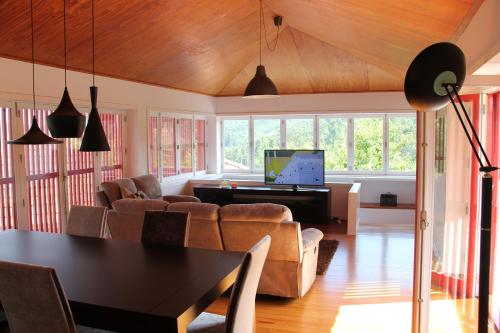a living room with a couch and a piano at Casa da Bichaca in Castelo de Paiva