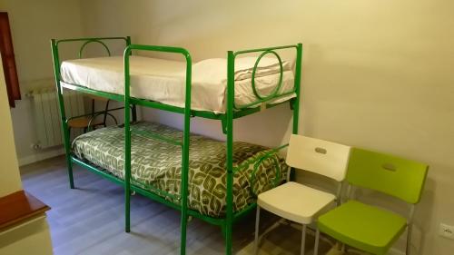 a room with two bunk beds and a chair at Casa Maria Teresa in San Donato in Poggio