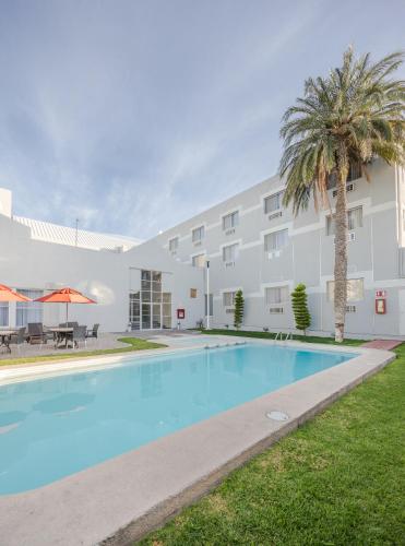 a large swimming pool in front of a building at Casa Grande Delicias in Delicias