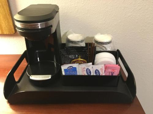 a coffee maker sitting on a table with toiletries at Lakeshore Inn Water Front in Moses Lake