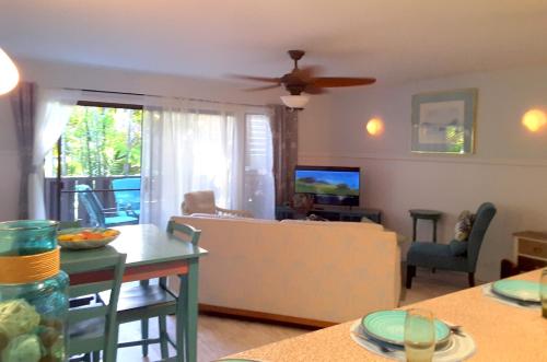 a living room with a couch and a table at Maui Tranquility in Kihei