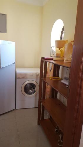a kitchen with a refrigerator and a washing machine at Saraiva's Guest House in Lagos