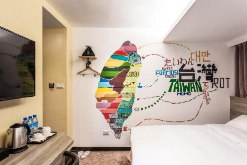 a bedroom with a wall with a map of korea at RF Hotel  Linsen in Taipei