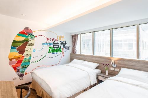 a hotel room with two beds and a mural at RF Hotel  Linsen in Taipei