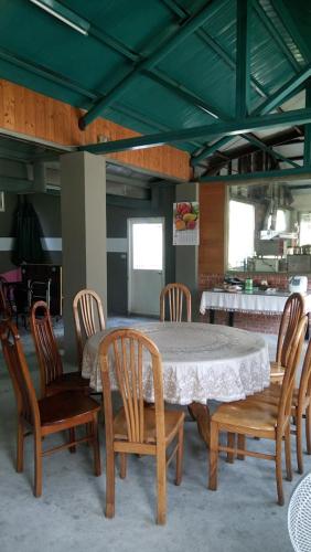 a table and chairs in a room with a table and a table and a table at Yellow Stone M.V. in Sanyi